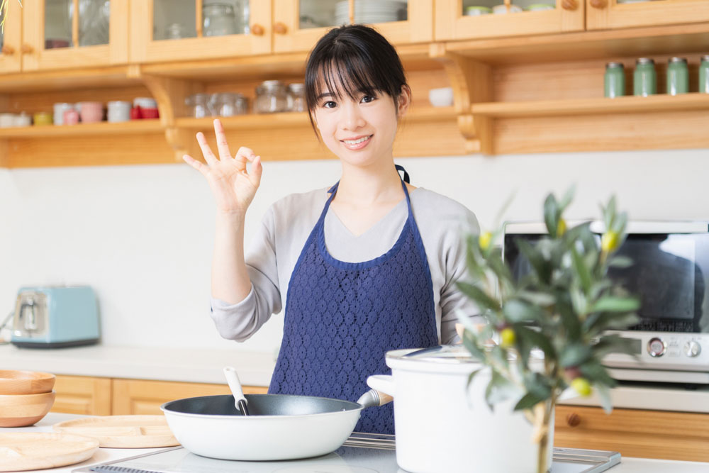 OKサインのエプロン姿の女性